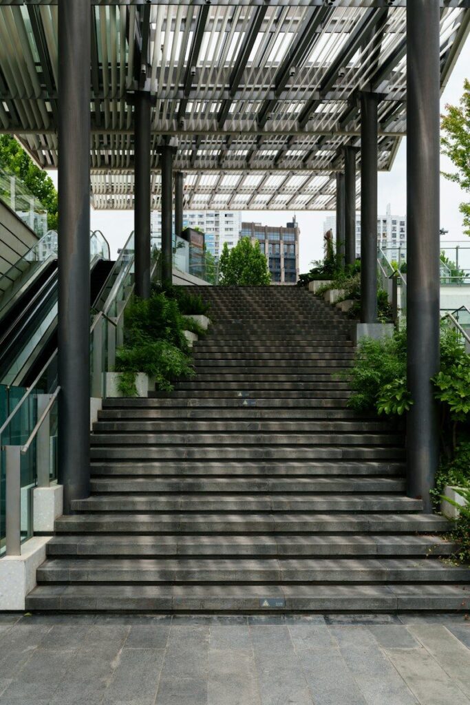 Modern outdoor stairway with escalators and greenery