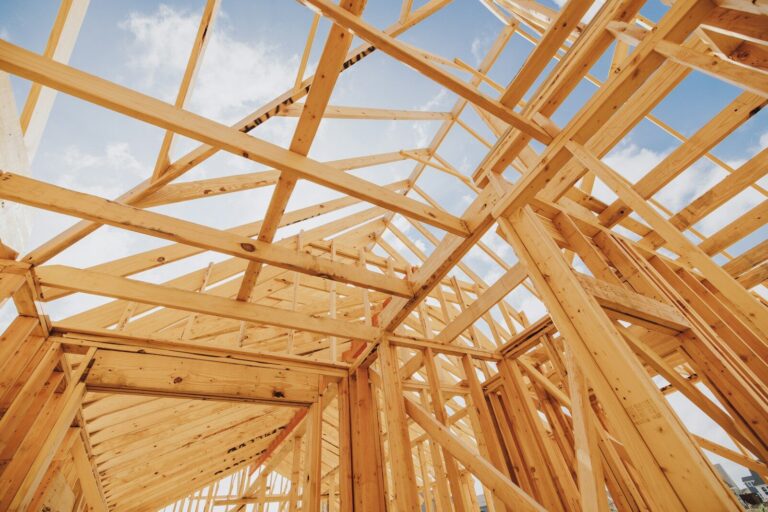 a wooden structure under construction under a blue sky